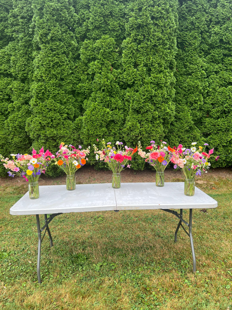 Mason jar bouquets across a table
