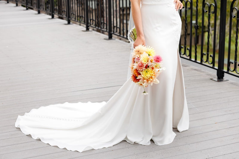 Bride with peach dahlia bouquet