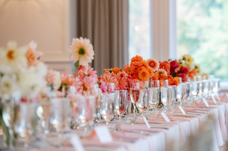 Long banquet table — peach centerpieces